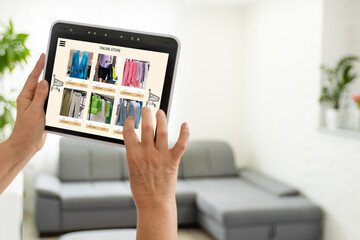 Fototapeta na wymiar Woman looking for new clothes in online store on digital tablet