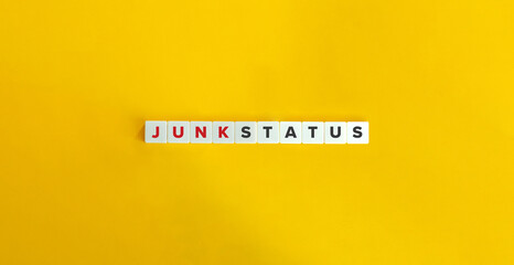 Junk Status Term on Letter Tiles on Yellow Background. Minimal Aesthetics.