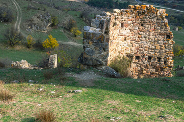 The wall of an ancient tower built of stones in the mountains to protect against attack. Ancient...