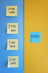 A lot of yellow stickers with words on blue background close up. Flat lay. Concept of freedom and support. Protest action. Stop war.