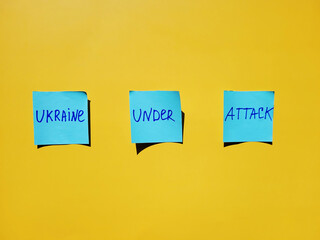Blue stickers with words on yellow background close up. Flat lay. Concept of freedom and support...