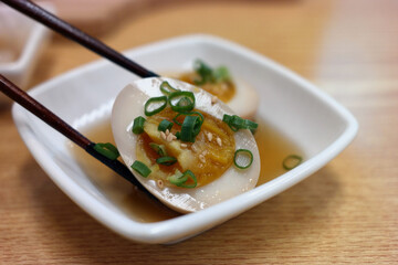 Egg paste made with soy sauce on a square plate.