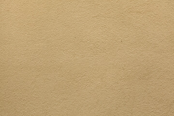 Yellow ochre painted stucco wall. Background texture