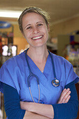 Loving the work I do. Portrait of a happy veterinarian standing with her arms folded.