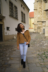 Fototapeta na wymiar Young Asian woman walking at historic european city.