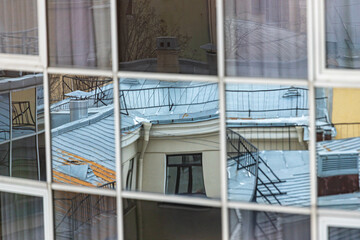 Reflection of the city in the stained glass of a high-rise building