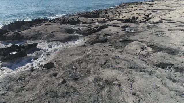 Drone flying low, over volcanic rock on Ko Olina Shore, Beautiful crystal clear sea, Hawaii