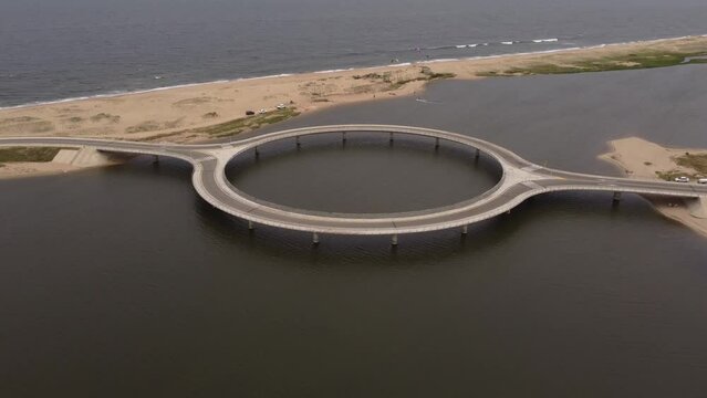 Aerial view over unusual circular shape bridge, Laguna Garzon. Uruguay, South America.