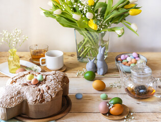Easter concept. Food composition with easter cake, colour eggs, flowers and easter decoration