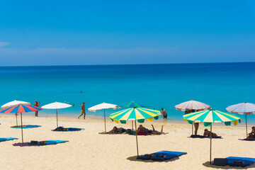 Fototapeta na wymiar Umbrella beach chair sea beach against blue sky