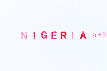 Fototapeta premium Red color ink rubber stamp in word nigeria on white paper background