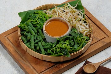 pecel is an indonesiantraditional food, made of a mixed vegetables (spinach, long beans, beansprout, cabbage) with peanut sauce.