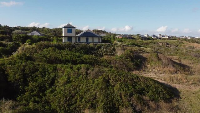 Orbit shot to classic house front to the ocean of La Pedrera in Uruguay. 4K aerial footage.