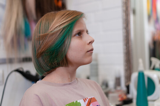 Teenage girl with colored green hair in a bob hairstyle