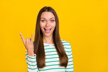 Photo of cool adorable woman wear striped shirt showing hard rock sign isolated yellow color background