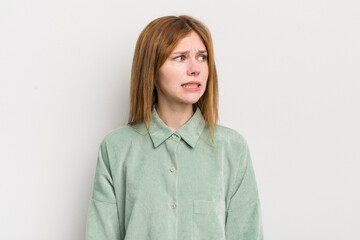 red head pretty woman looking worried, stressed, anxious and scared, panicking and clenching teeth