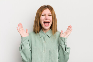 red head pretty woman feeling happy, excited, surprised or shocked, smiling and astonished at...