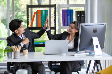 Teamwork Deal Cooperation Partnership business people giving hi-five after successful work in the office.