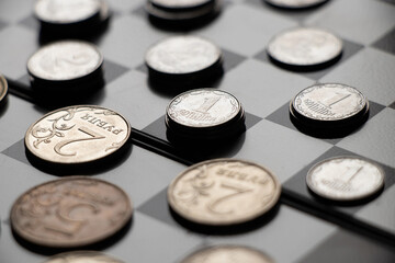 Obraz na płótnie Canvas Ukrainian hryvnia and Russian rubles lie on a chessboard, sanctions in Russia, finance