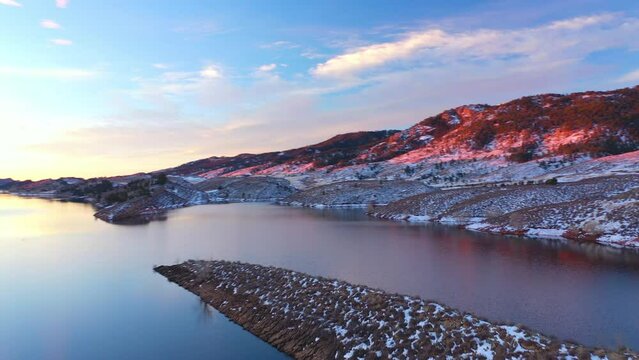 Aerial droen shot of Molas Lake in Colorado, United States with mountains in the background dring winter season at sunset.