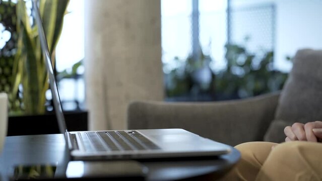 In this close up shot you can see businesswoman hands working with laptop computer. She is typing on keyboard: writing, coding or calculating. In the end she hits the enter key to send completed file
