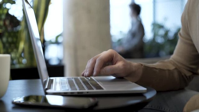 Businessman hits the enter key to send completed file, do upload action, finish work project, send letter, save file or do another concluding action.