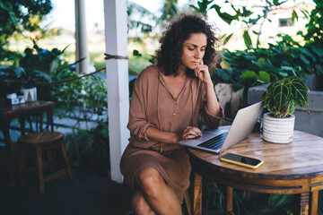 Millennial IT professional keeping digital nomad and freelance lifestyle using laptop computer for...