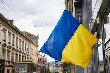 Ukrainian flag in city building. Lviv during war