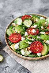 Cucumber avocado tomato salad with arugula and feta. Tasty summer salad. Delicious breakfast