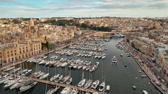 Aerial view of Birgu city - famous old town. Three cities and marina with yacht. Malta