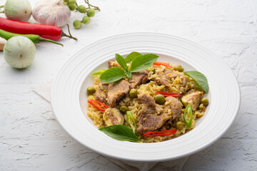 Green Curry Fried Rice with pork meat and basil in white plate