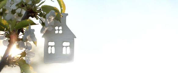 house layout silhouette against the background of a blossoming fruit tree at dawn. profitable home...