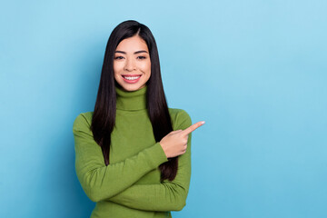 Photo of sweet millennial brunette lady index promo wear green pullover isolated on blue color background