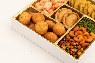 Indian Shahi Mithai Gujia Or Gujiya, Spicy Crispy Snacks Namkeen Also Called Nimki, Mathri, Matar, Kachori, Mixture Decorated in Giftbox. Food Theme For Holi, Deepawali, Rakshabandhan, Dussehra, Rakhi