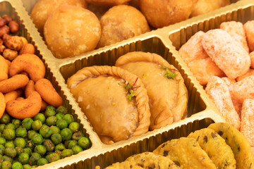 Indian Shahi Mithai Gujia Or Gujiya, Spicy Crispy Snacks Namkeen Also Called Nimki, Mathri, Matar, Kachori, Mixture Decorated in Giftbox. Food Theme For Holi, Deepawali, Rakshabandhan, Dussehra, Rakhi