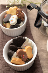 Assorted decorated biscuits on white bowls