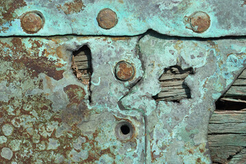 A close-up of weathered wood and corroded metal
