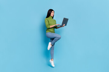 Full body photo of funky millennial brunette lady jump with laptop wear jumper jeans sneakers...