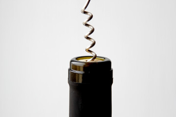 removing a wine cork from a bottle with a corkscrew 
