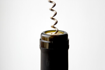 removing a wine cork from a bottle with a corkscrew 