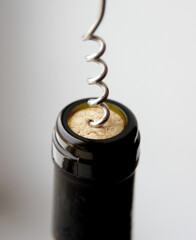 removing a wine cork from a bottle with a corkscrew 