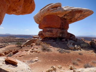 Massive cliff side balancing rock formations and hoodoos in the Bears Ears wilderness area of Southern Utah.  