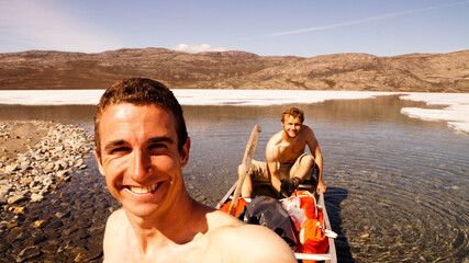 Hikers on the Arctic Circle Trail in a canoe on a lake between Kangerlussuaq and Siimiut in...