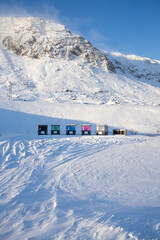 Vertical photo of winter garbage in Iceland. Photo of waste bins surrounded by snow in the Arctic. 