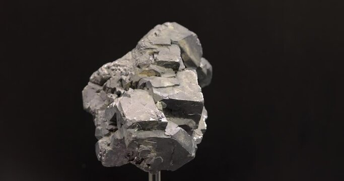 rotation of Crystal of galenite on black background