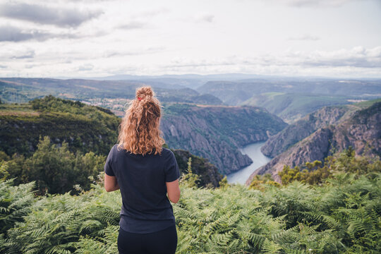 Woman hiker standing and looking at Sil Canyon
