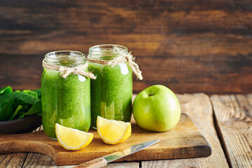 Fresh green vegan detox smoothie.Fresh healthy green spinach and apple smoothie served in jar with...