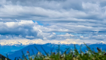 Mountain peak of Hahnkogel (Klek) with panoramic view in spring on the Karawanks, Carinthia, Austria. Borders Austria, Slovenia, Italy. Triglav National Park. Alpine meadows. High grass