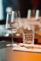 Vertical shot of a table setting with glasses and cutlery in a restaurant