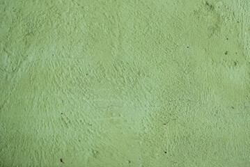 A green colored old wall texture background.